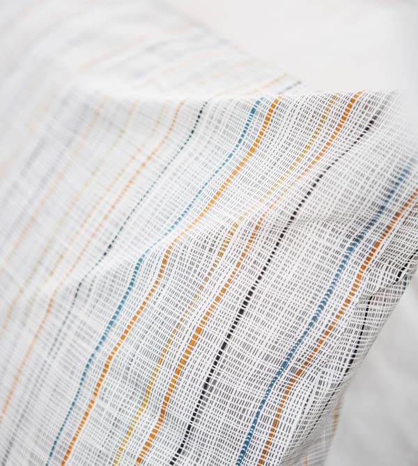 A close-up of a simple striped pillow.
