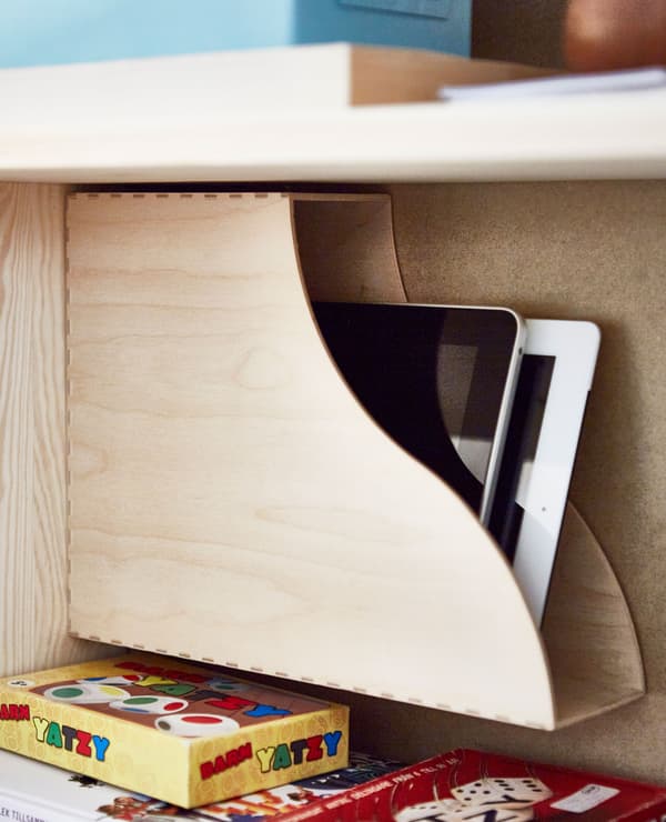 A close-up of a wooden magazine file holding tablets.