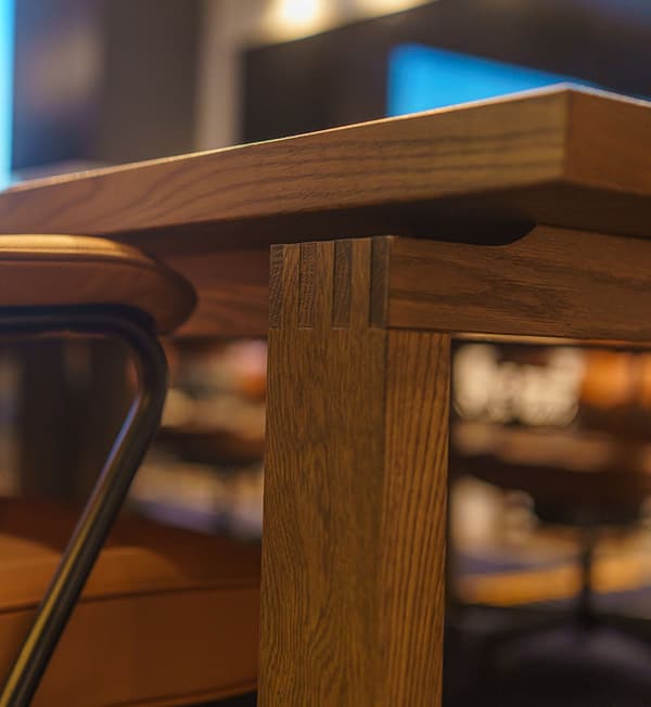 A close-up of a wooden MÖRBYLÅNGA table leg.