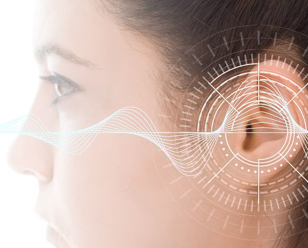 A close up of an ear with soundwaves coming out of it.