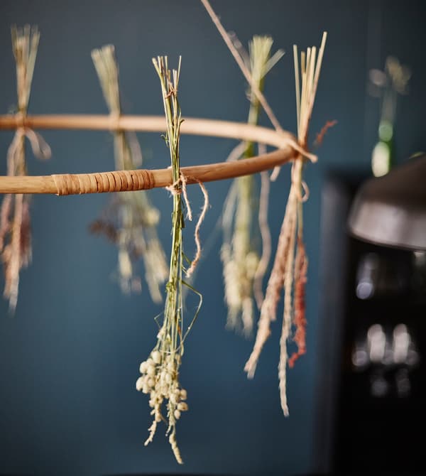 A close-up of dried flowers tied and hanging off a play hoop.