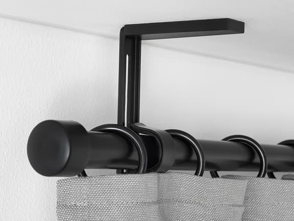 A close-up of how a ceiling-mounted curtain rod looks like