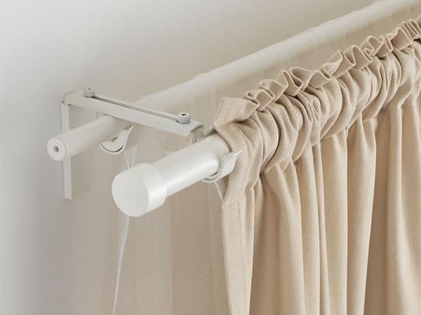 A close-up of how a wall-mounted curtain rod looks like