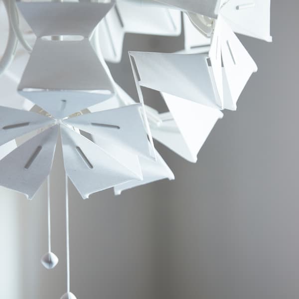 A close-up of RAMSELE pendant lamp made in a geometric shape that unfolds when the strings are pulled.