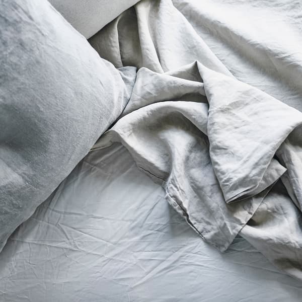 A close up of rumpled bed textiles.