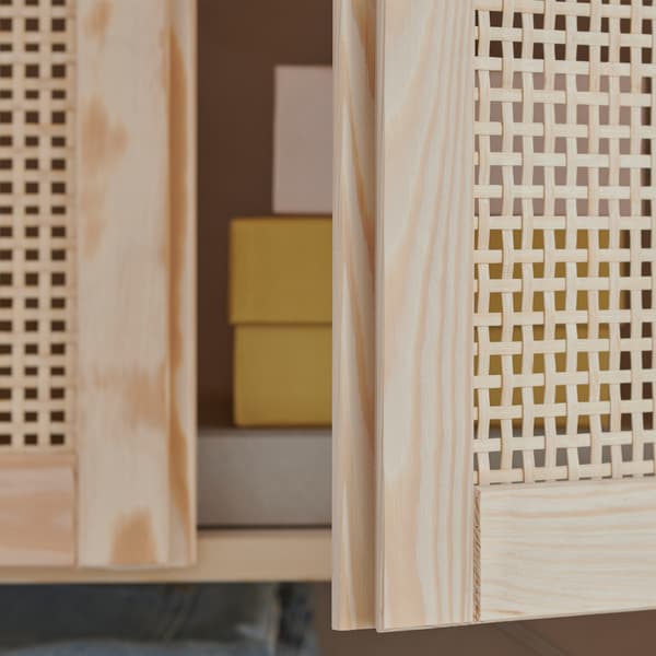 A close-up of the light bamboo IVAR door standing ajar in the light pine frame of IVAR storage system.
