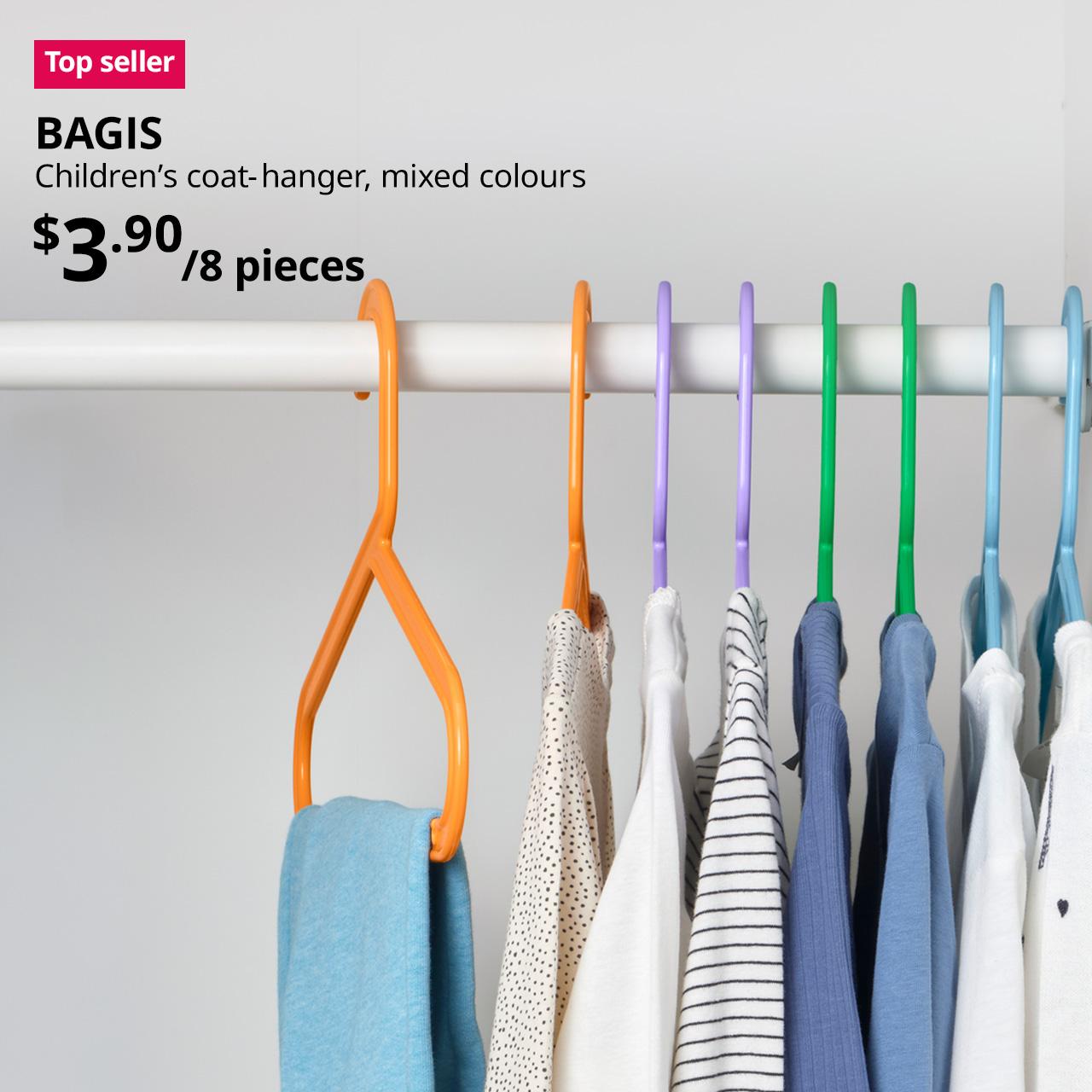 A close-up shot in a white children's wardrobe featuring BAGIS children's coat-hanger in mixed colours. On the top left corner, a red/pink tag with white text that reads 'Top seller', followed by black text overlaying image that reads 'BAGIS, Children's coat-hanger, mixed colours, $3.90/8 pieces'.