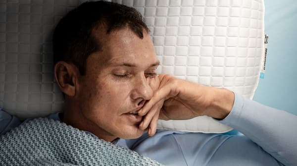 a close up shot of a person sleeping on their back