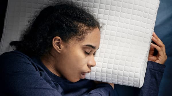 a close up shot of a person sleeping on their side