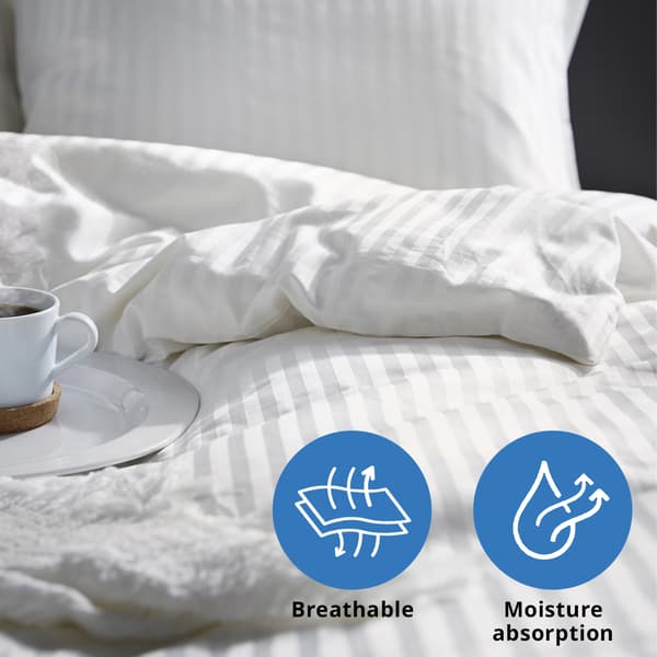 A close-up shot of white NATTJASMIN duvet cover with pillowcase.