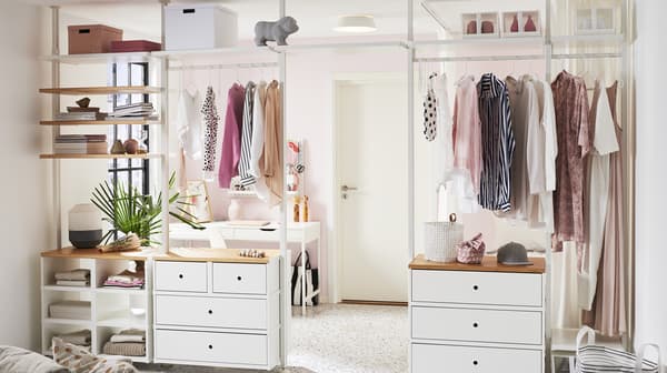 A closet room with ELVARLI cabinets for hanging clothes and storing.