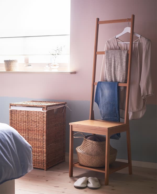 A clothes corner with a chair and basket for wear-again clothes and a laundry bin for dirty clothes. 