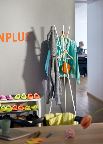 A coat rack at the entrance of the office