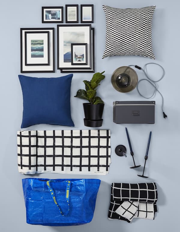 A collage of textiles and decorative objects in black and white, with a hint of blue.