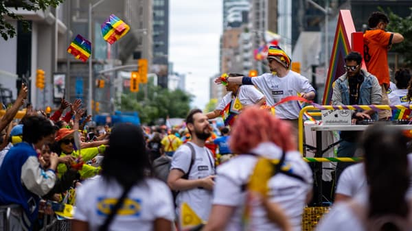 A collection of people are gathered for the pride parade.