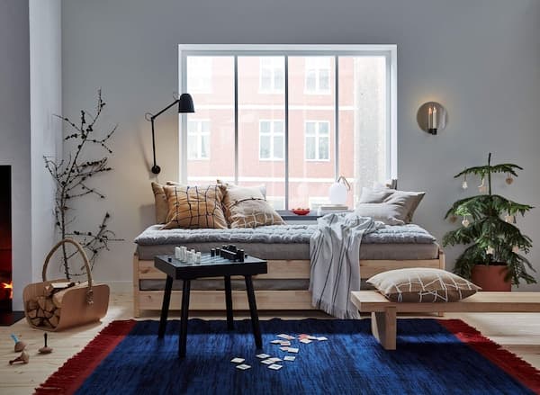 A collection of products from the VARMER series incuding a rug and textiles.