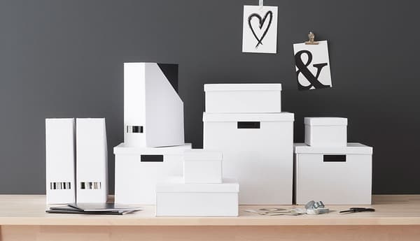 A collection of various size white TJENA boxes and magazine files.