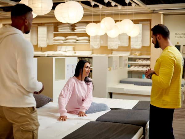 A couple buying i a bed in a IKEA store.