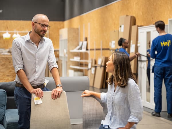 A couple chatting in the IKEA As-is.