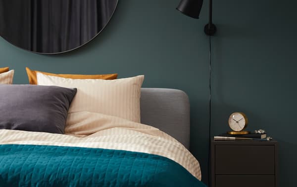 A couple cuddle asleep in a SLATTUM upholstered bed