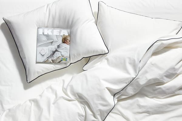 A couple in bed with a guitar in an industrial style loft bedroom.