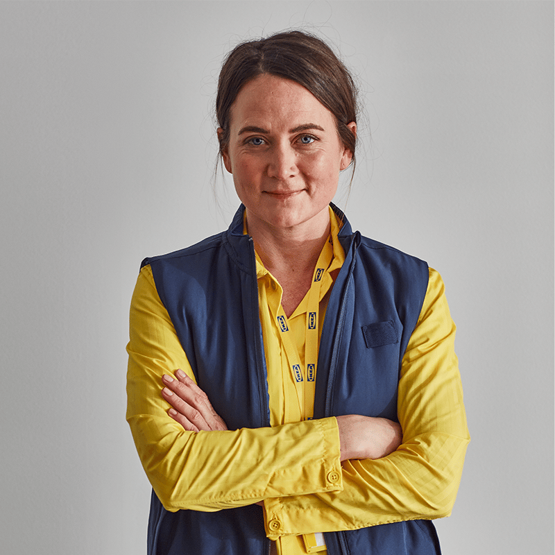 A coworker dressed in Ikea clothes, with a yellow shirt and blue vest