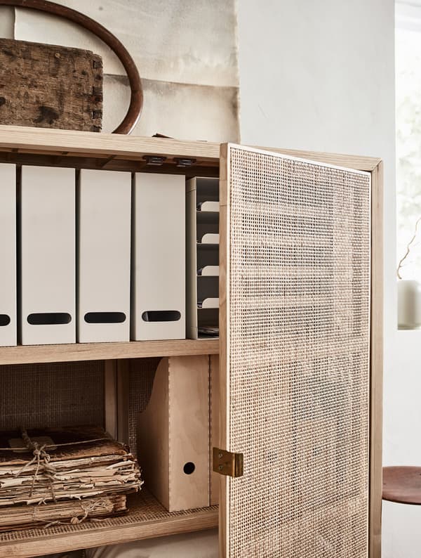 A cupboard with storage boxes, documents and bed linen.