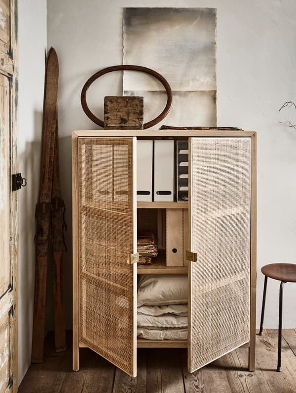 A cupboard with storage boxes, documents and bed linen.