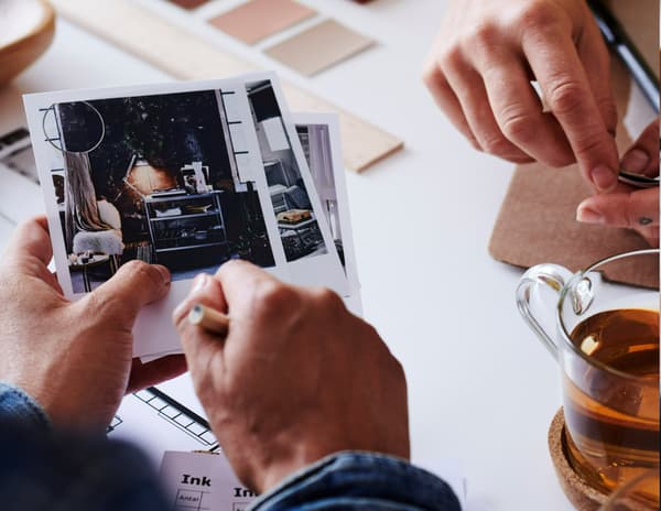 A customer holding pictures of inspirational images.
