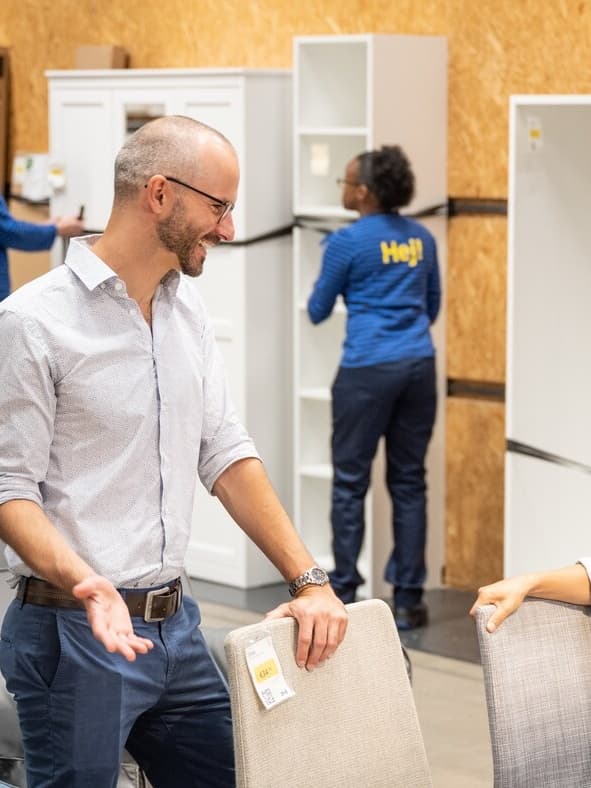 A customers stands in Re-shop and Re-use, in store