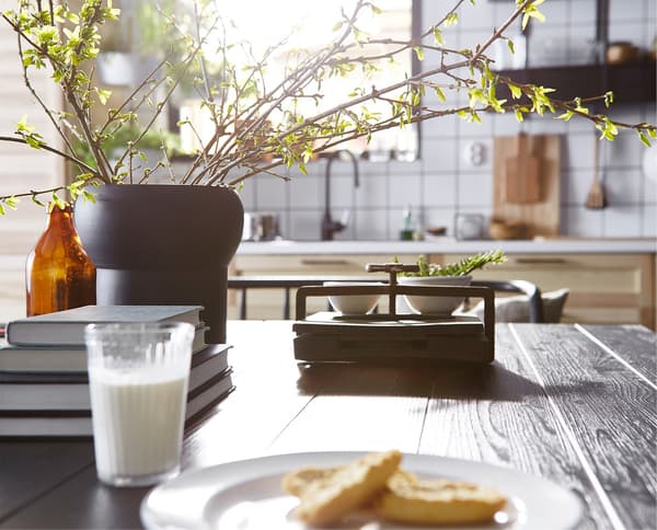A dark wood dining table that’s the hub of activity in this Swedish kitchen.