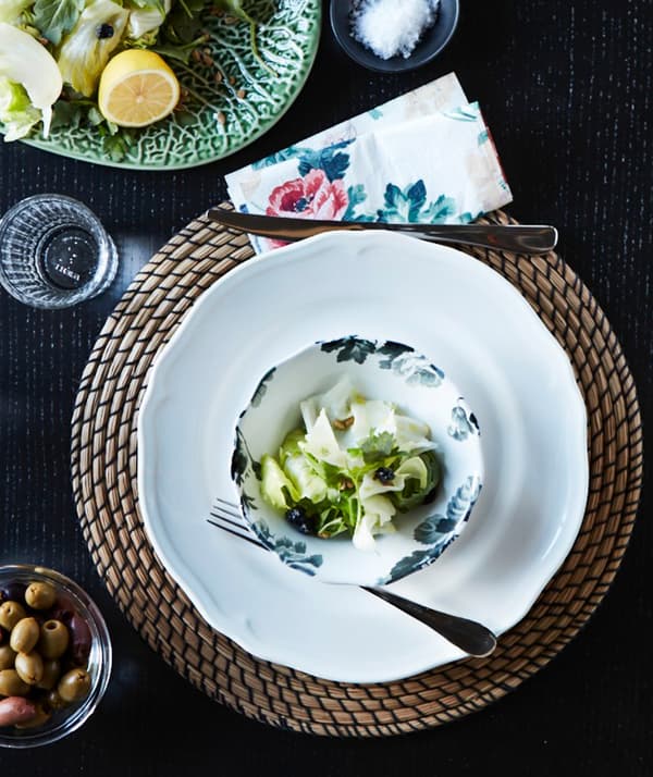 A decorative, round IKEA LÄTTAD seagrass place mat under a plate and bowl.