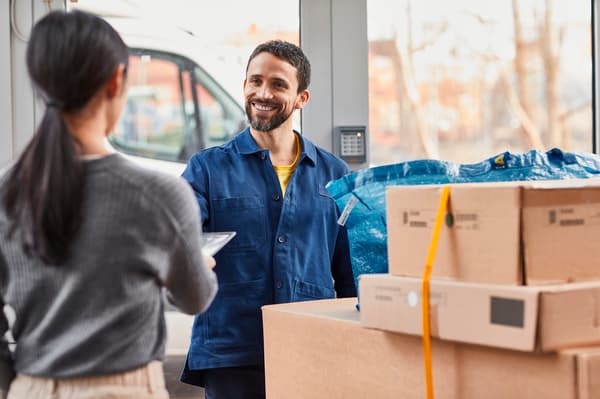 A delivery person is picking up multiple packages from a customer who wishes to return them. 