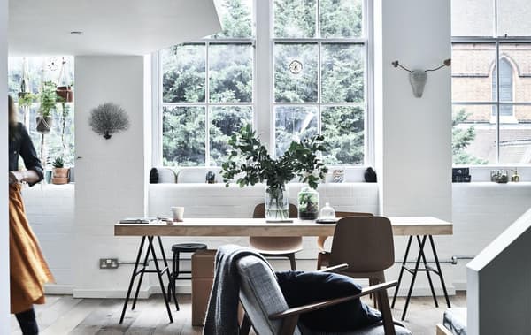 A dining table in front of a large window.