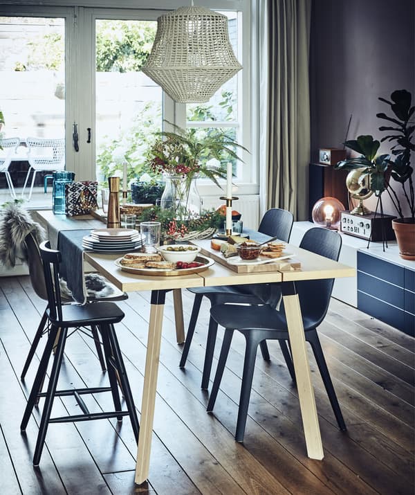 A dining table with a colourful setting for four people.