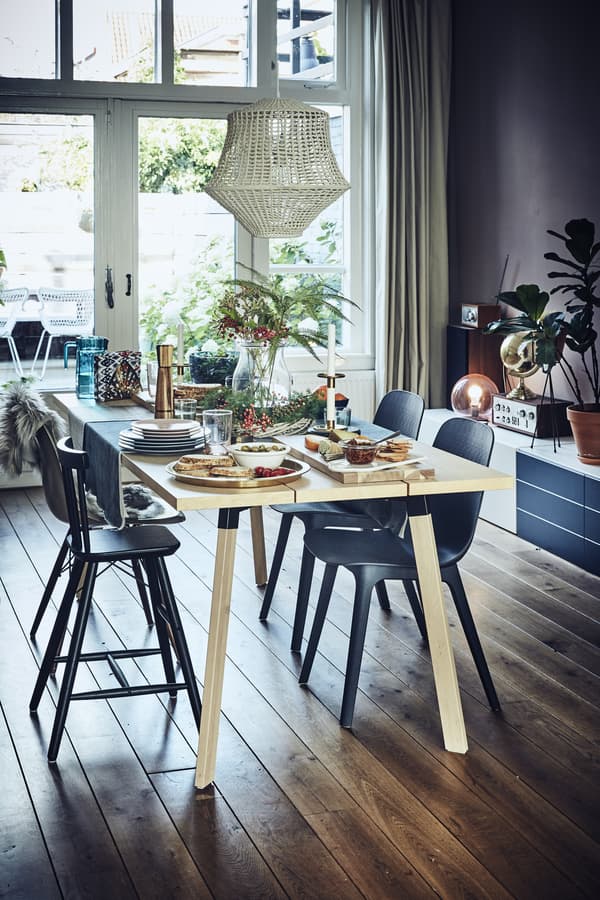 A dining table with a colourful setting for four people.