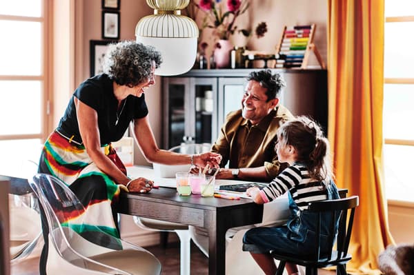 A family around the table talking and smiling.