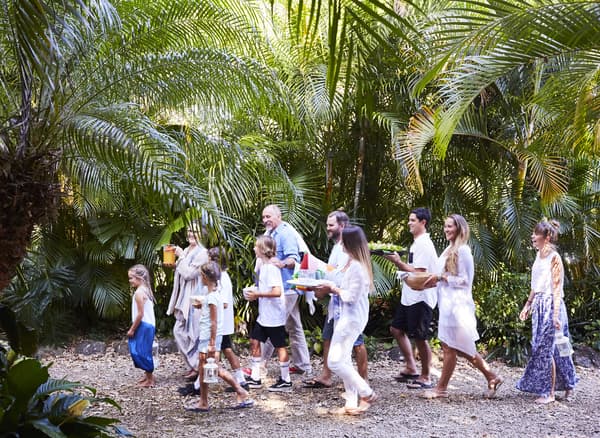 A family carrying food to the barbecue.