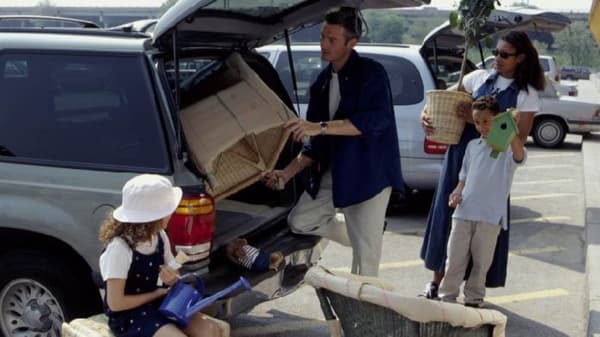 A family loading new IKEA Furniture into the back of a truck