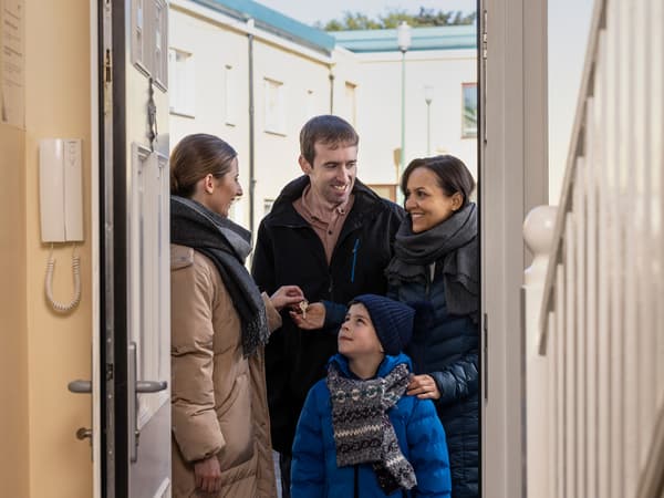 A family meeting a key worker at their new home