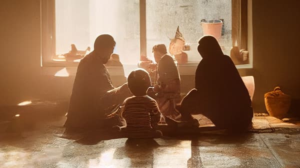 A family of four sitting in a circle in a living room.