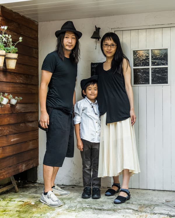 A family portrait of Kaoli, Shige and Tokiwa outside their tiny home.
