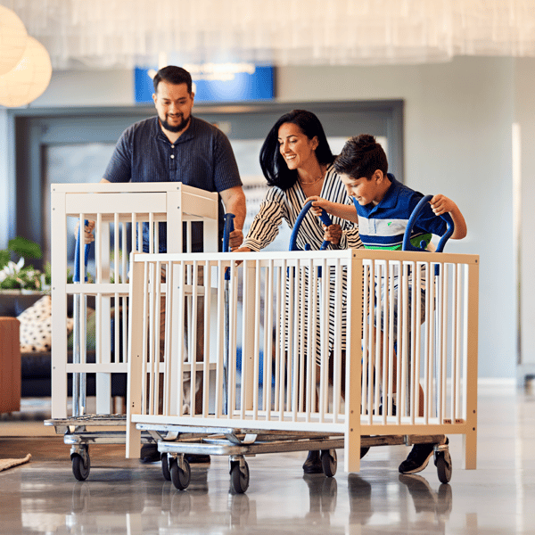 A family shopping at IKEA with trolleys.