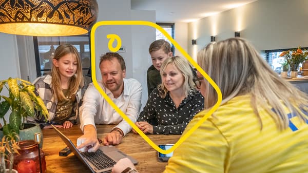 A family sits around a table with an IKEA employee.