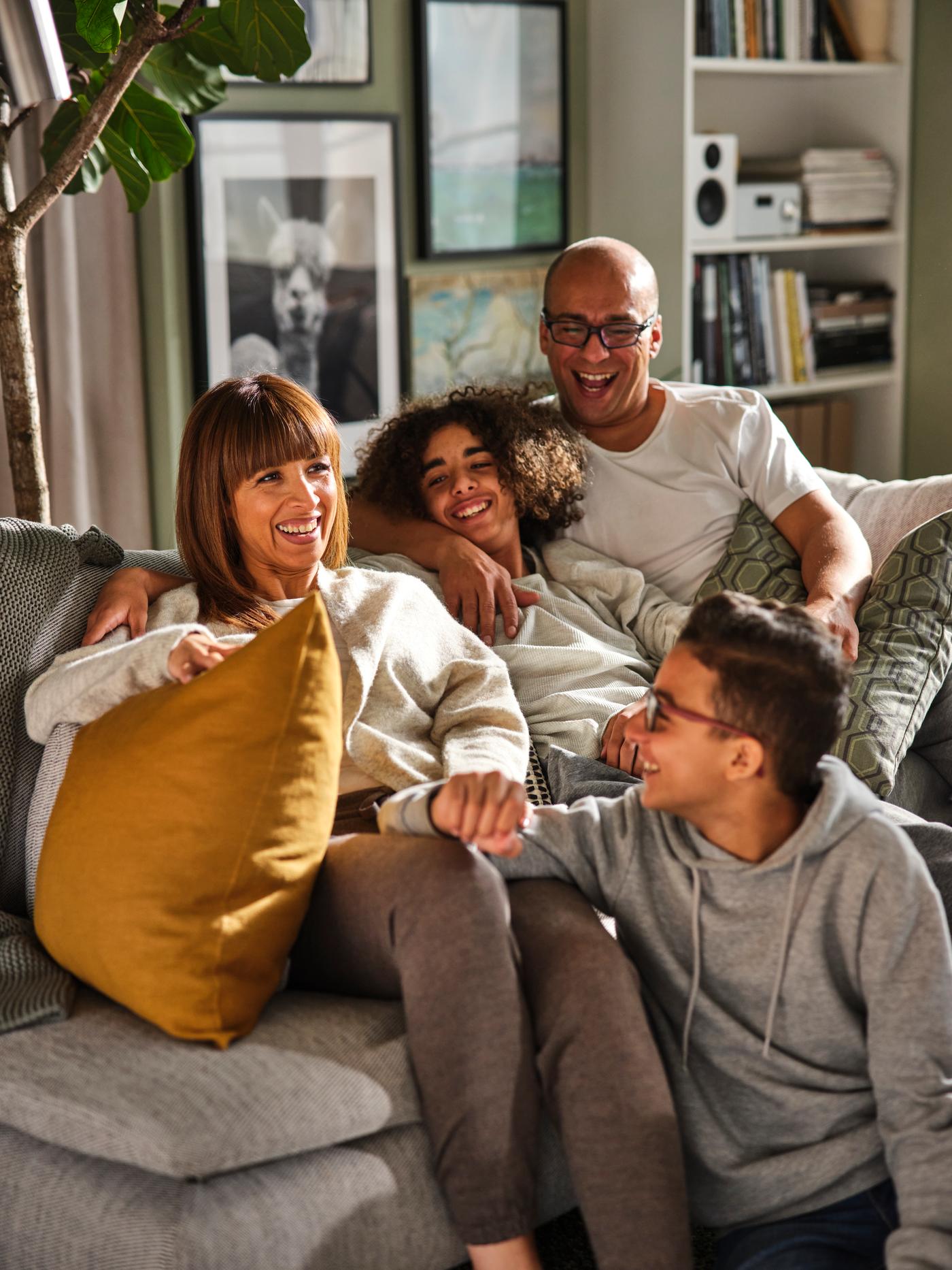A family sitting in a sofa