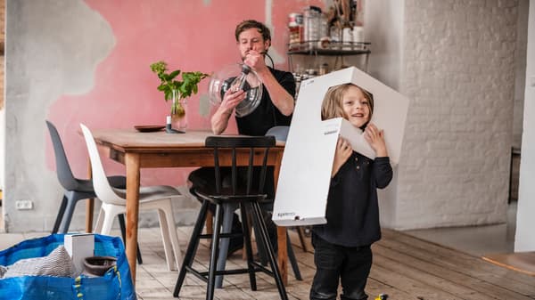 A father and his daughter unpack a lamp.