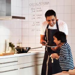 A father cooking with his young son