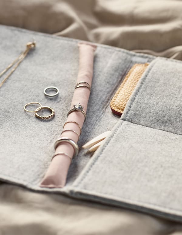 A felt hanging organiser turned into a diy jewellery travel case with spots for rings, necklaces, earrings, etc.  