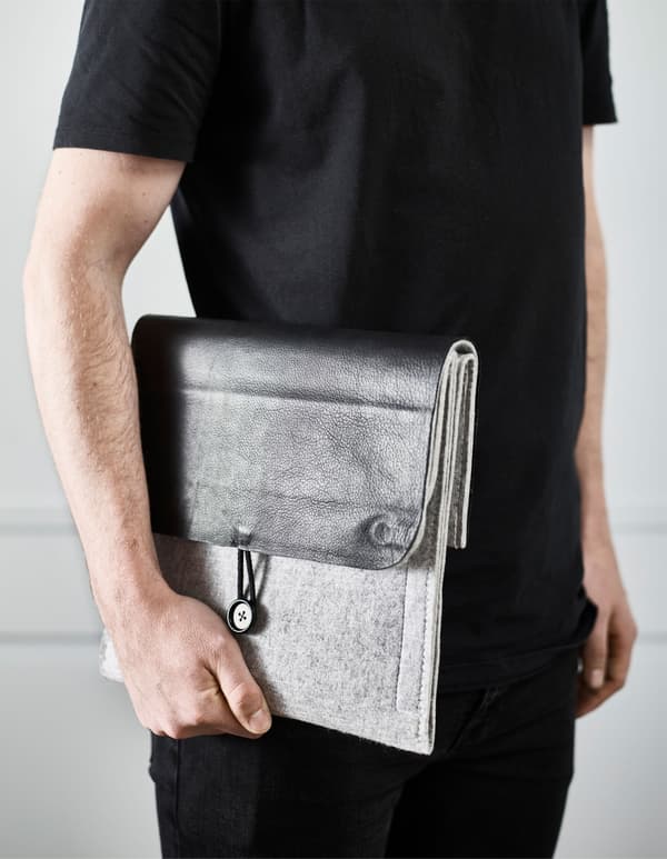 A felt hanging organiser turned into a diy work tech clutch with space for a tablet and a notebook.  