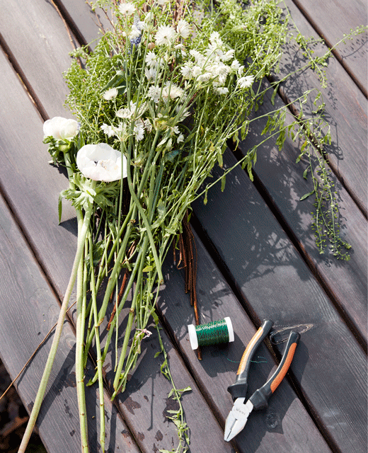 A flower crown hangs off the side of a dining chair.